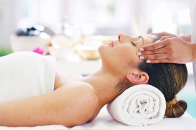 female therapist doing tickle massage on female head