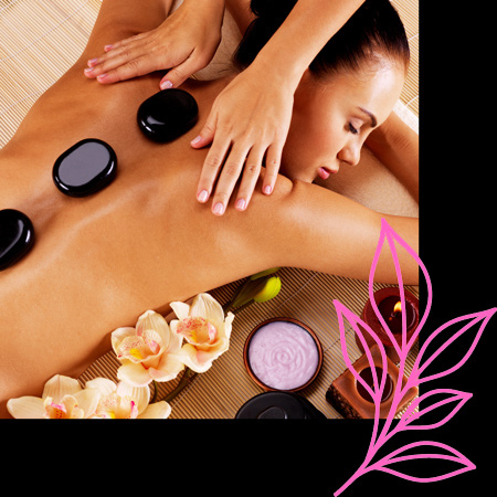 adult woman having hot stone massage in spa salon