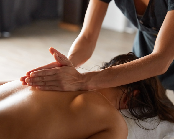 woman having full body massage at spa salon